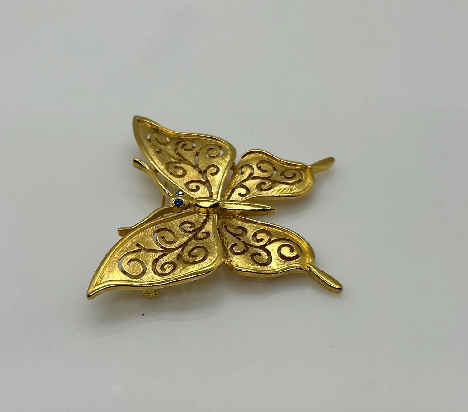 Crown Trifari Gold Tone Filigree Butterfly Brooch with Blue Eyes